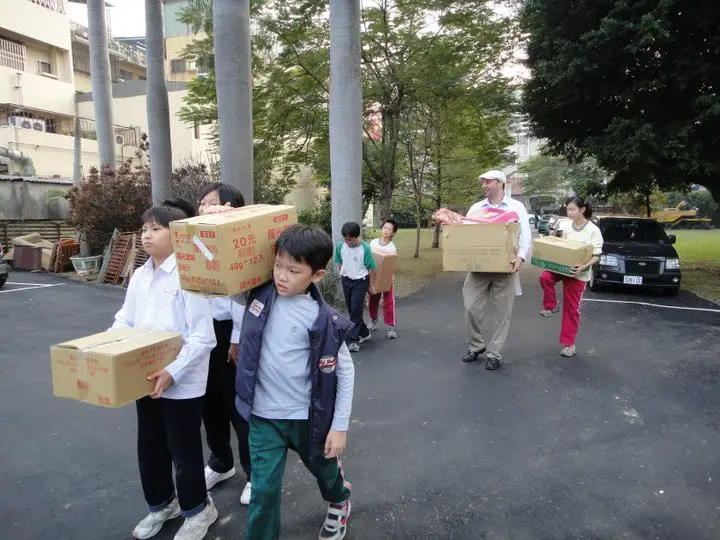 Best Language Center students and teachers delivering Xmas gifts to the orphanage